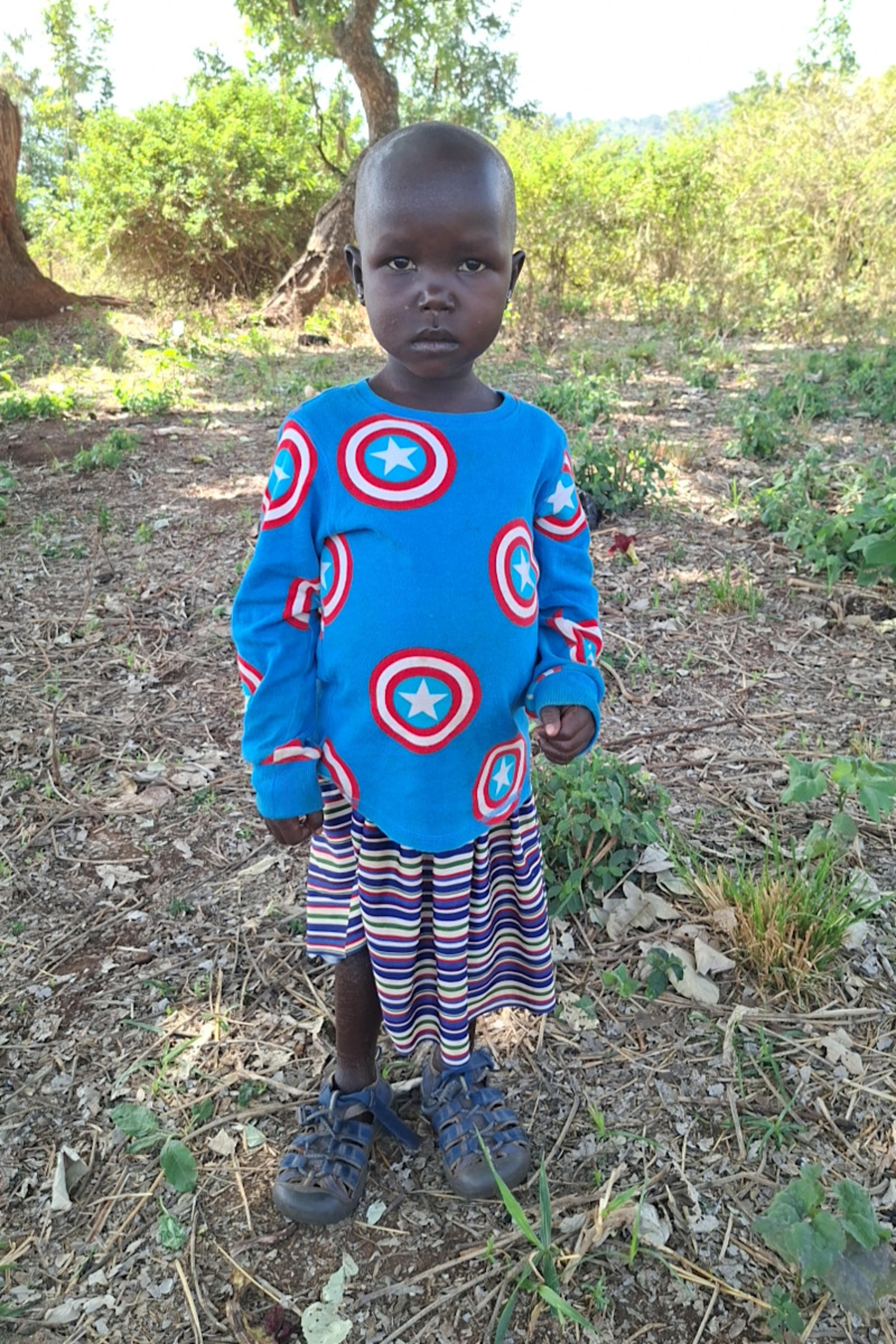 An unsponsored girl named Acheng from Uganda who lives in an AIDS-affected area, is vulnerable to exploitation and has waited 213 days for a sponsor.