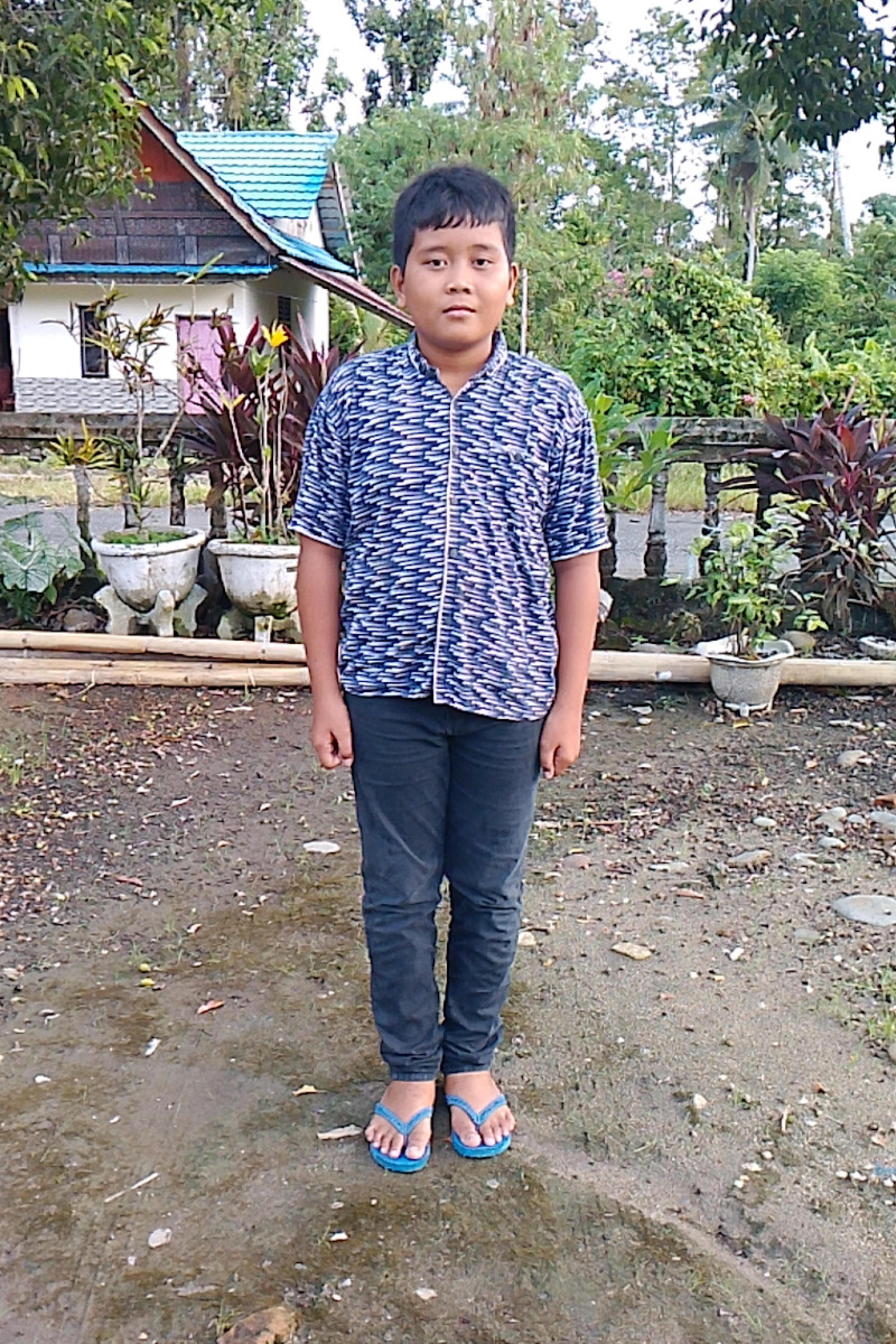 An unsponsored boy named Alfris from Indonesia who has waited 650 days for a sponsor.