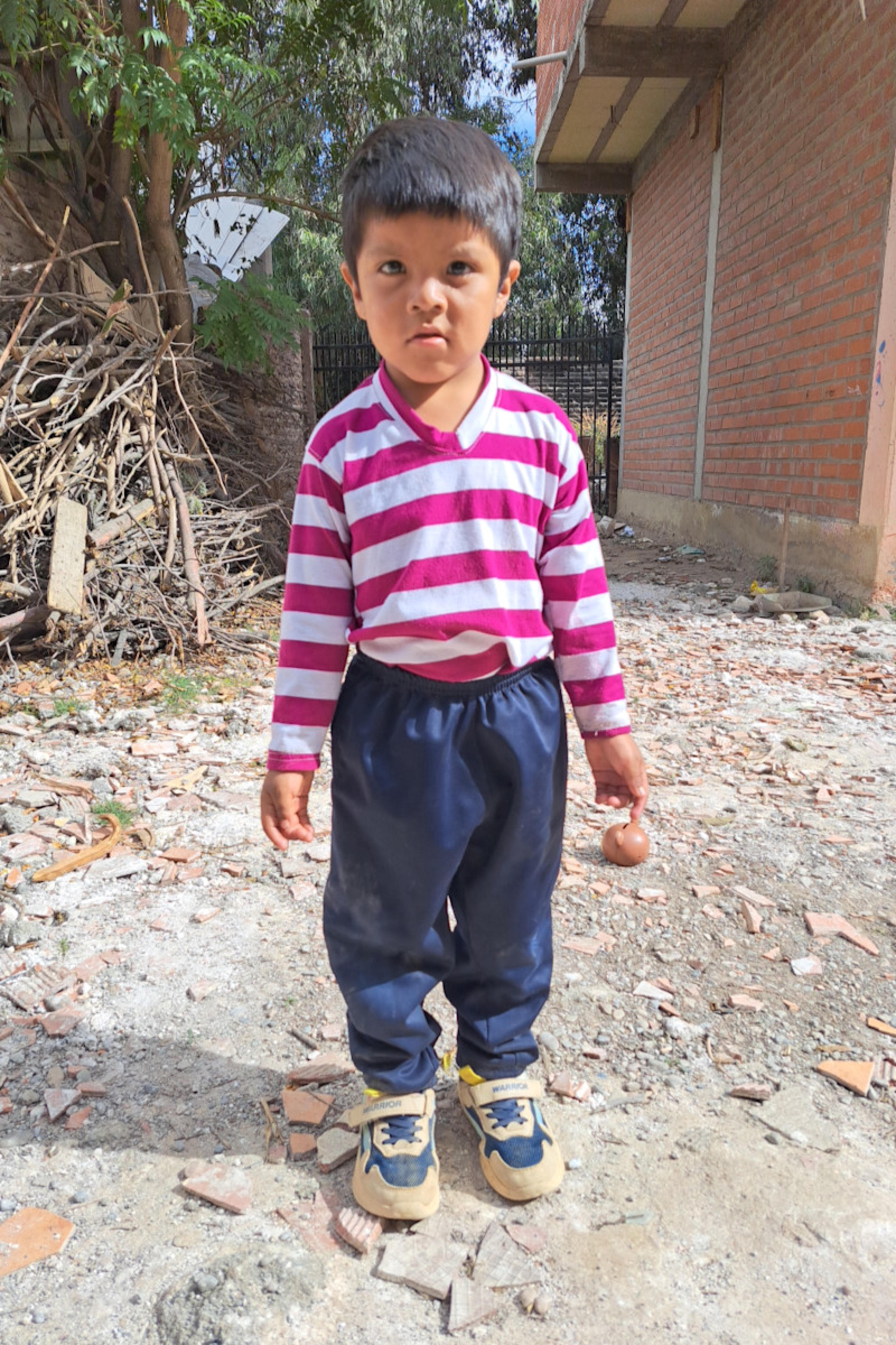 An unsponsored boy named Israel from Bolivia who has waited 525 days for a sponsor.