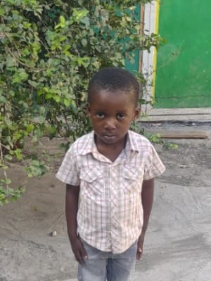 An unsponsored boy named Mandinhio from Haiti who is vulnerable to exploitation and has waited 420 days for a sponsor